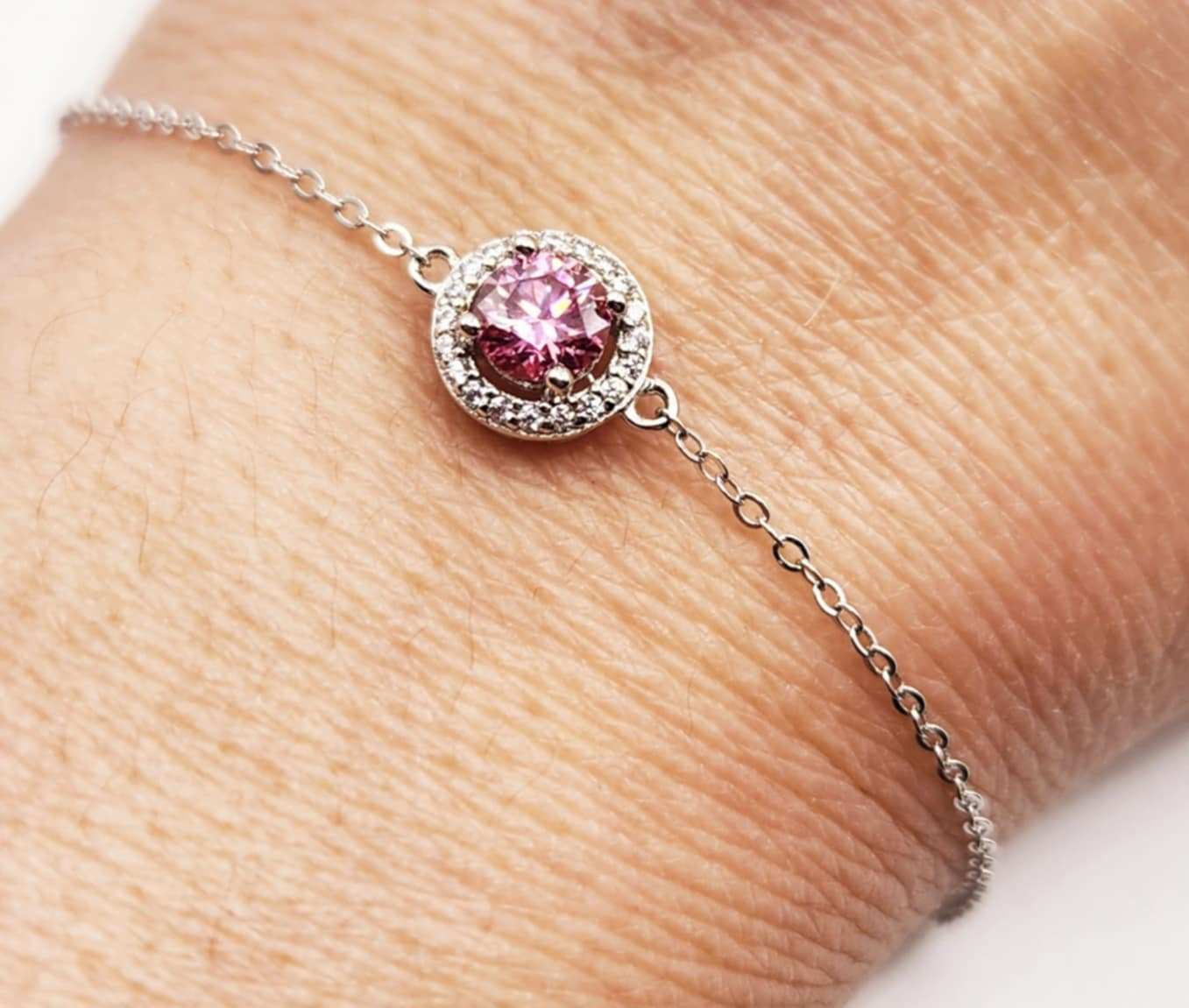 Halo Pink Sapphire Bracelet with silver chain and round gemstone.