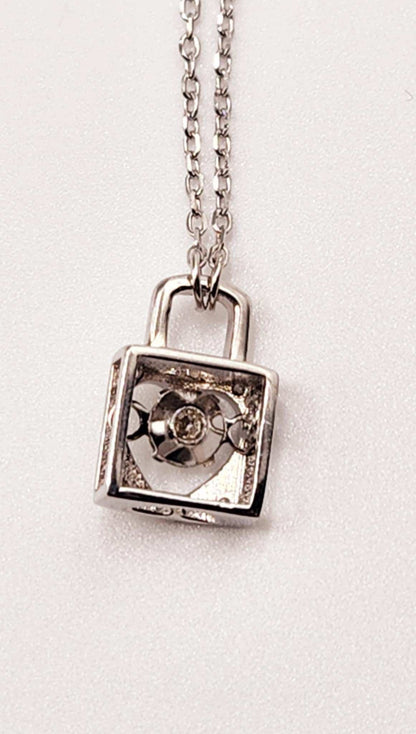 Dancing Gemstone Love Lock Pendant in sterling silver with round cut gemstone.