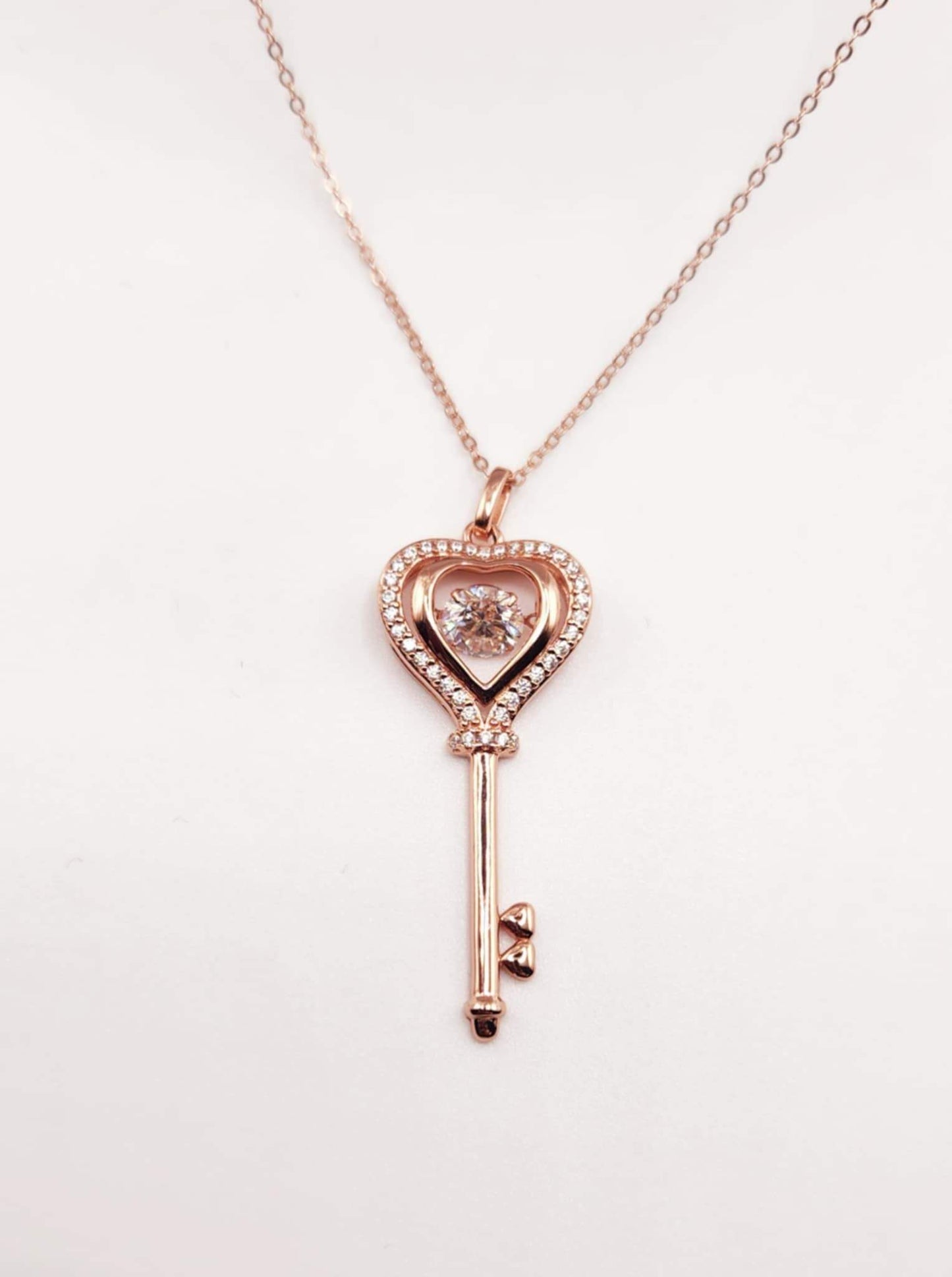 925 silver rose gold plated key pendant necklace with round cut moissanite stone.