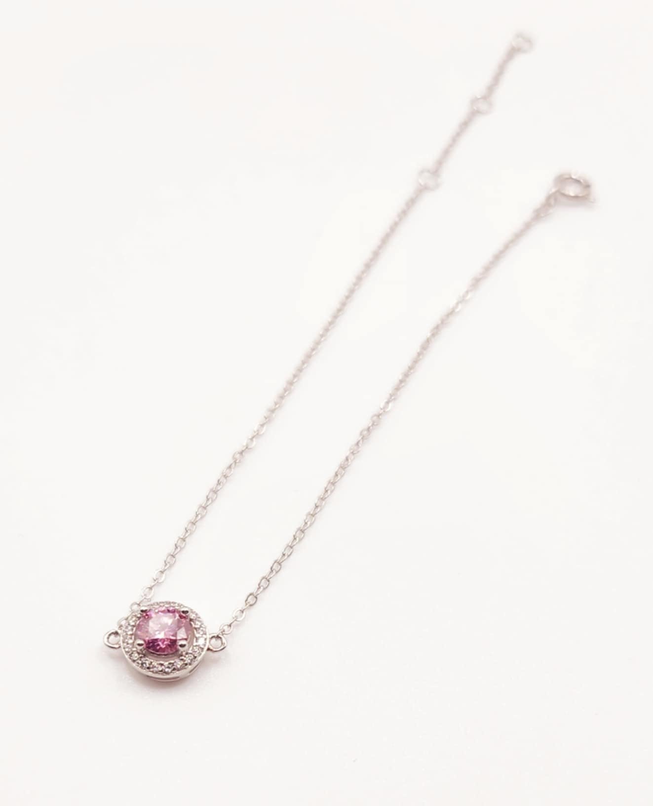 Halo Pink Sapphire Bracelet with 4mm round lab-created gemstone on 7.5-inch sterling silver chain.