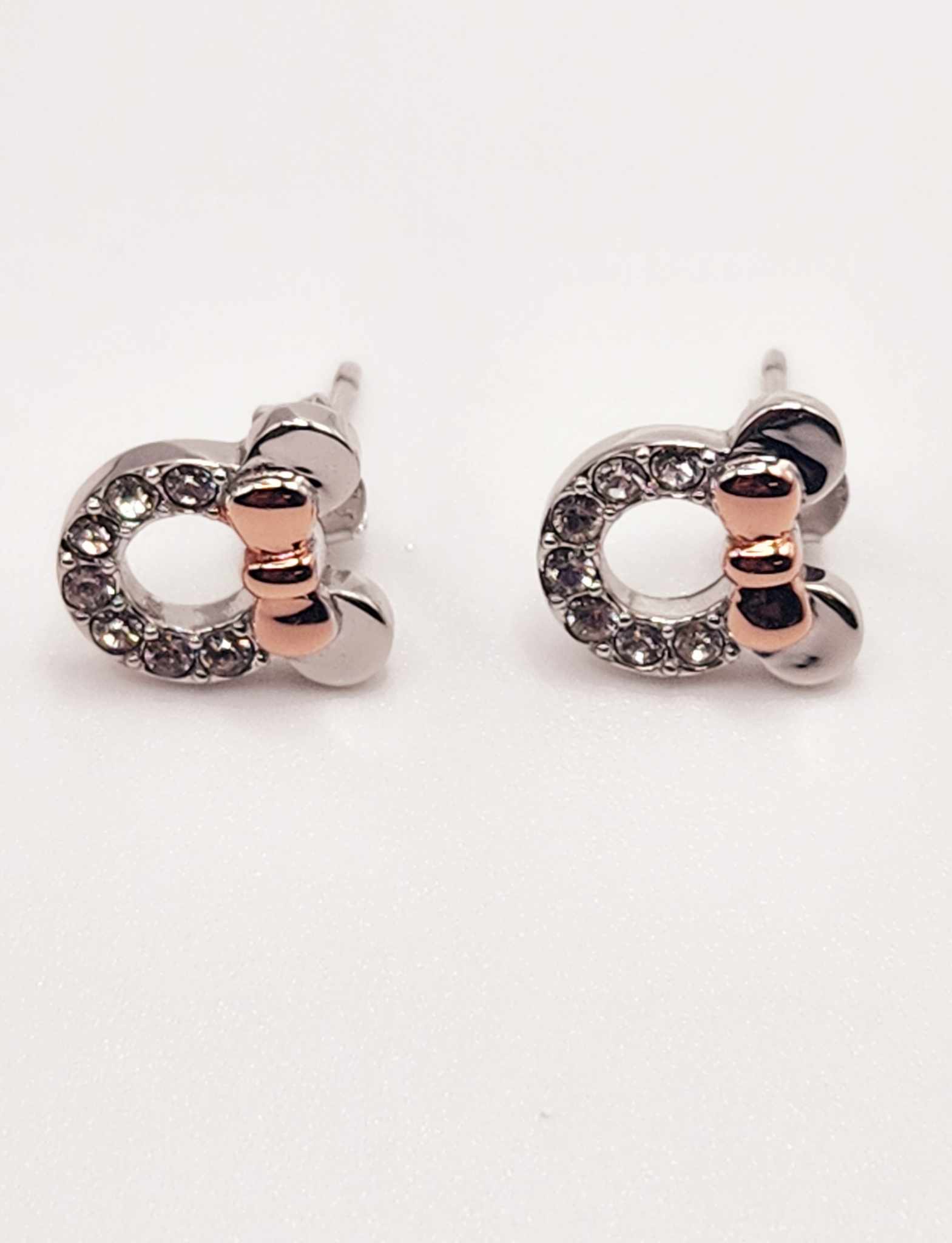 Minnie Mouse inspired pave stud earrings with rhinestones and silver bow design.